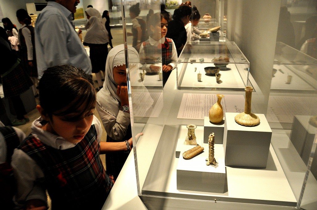 A group of primary school children are scrutinizing various artifacts. The girl close to me was looking at glass containers which date back from the Sasanian period (from 226 CE) to the early Islamic and Umayyad period (750 CE).