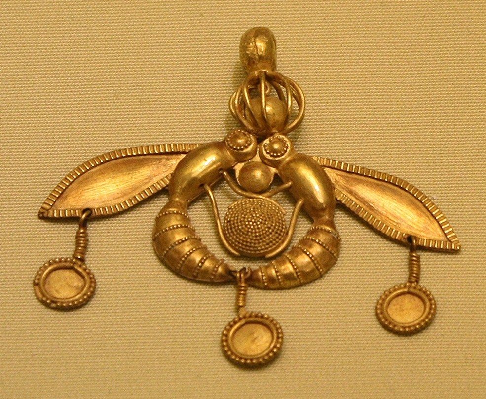 A solid gold Minoan pendant depicting two bees clutching a honeycomb (1800-1700 BCE), found in the Old Palace cemetery at Chrysolakkos near Malia, Crete. (Herakleion Archaeological Museum, Crete)