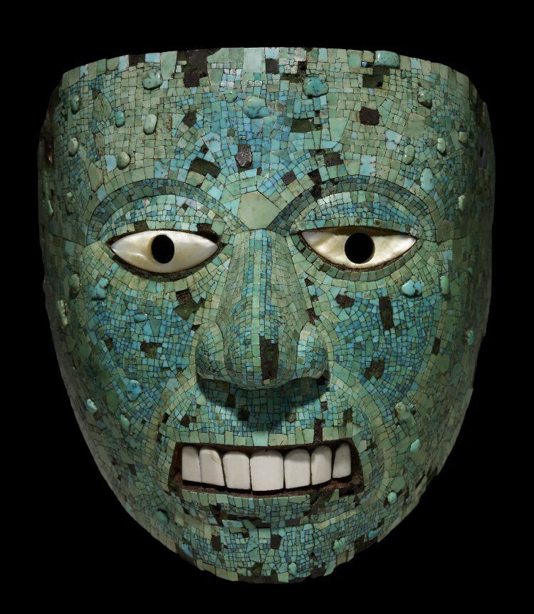 A turquoise mosaic mask representing Xiuhtecuhtli, the Aztec god of fire, 1400-1521 CE. The mask is of cedar wood with mother-of-pearl eyes, conch shell teeth and once with gold leaf on the eyelids. (The British Museum, London). 