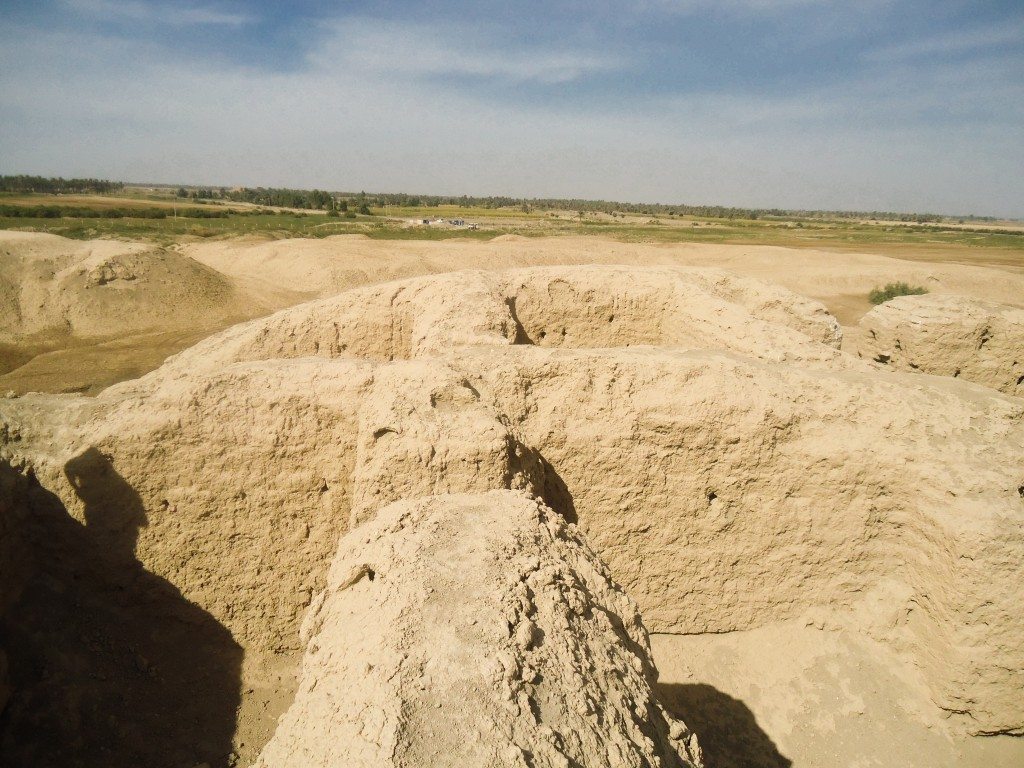Note the room-like chambers within the mound. Some farms appear on the horizon. 