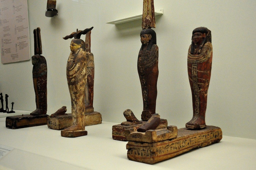 These are wooden statues of Patah-Seker. Patah was the protector god of artisans while Osiris was the god of the underworld. Seker (bird) was the god of the cemetery. When a person dies, a piece from his body is taken, embalmed and placed in a box, and then sealed with a wax. Thereafter, a Seker bird is put on the top. Ancient Egyptians, believed that the deceased person becomes immortal by doing these steps. 