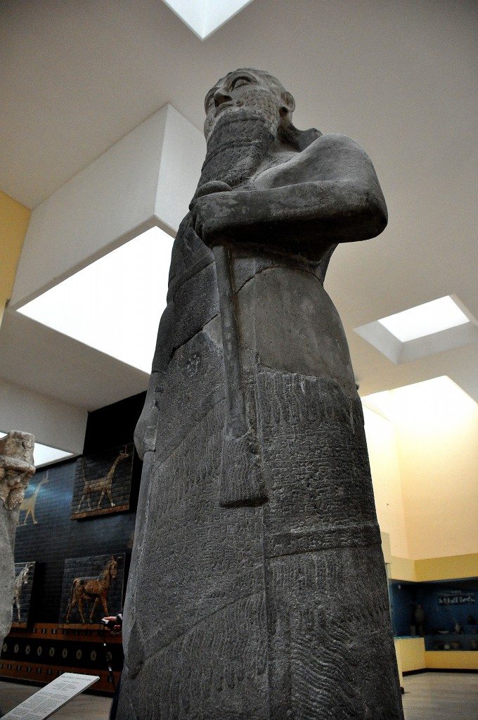 Basalt statue of Shalmaneser III, king of Assyria from 858-824 BCE. The cuneiform inscriptions on the statue narrates a brief account of the king's genealogical titles and characteristics. The inscriptions also say that the king's military campaigns against the lands of Urartu, Syria, Namri, Que, and Table have come to an end. On the background, a sirrush and an auroch from Babylon appear. 