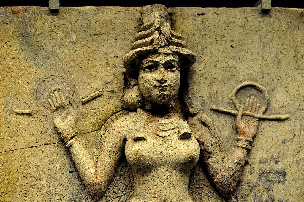 A close-up image of the relief. showing the upper part of the nude female deity. 