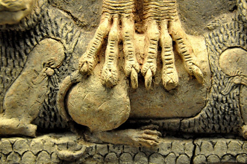 The deity's feet are of a bird. Note the scutes and the talons. 