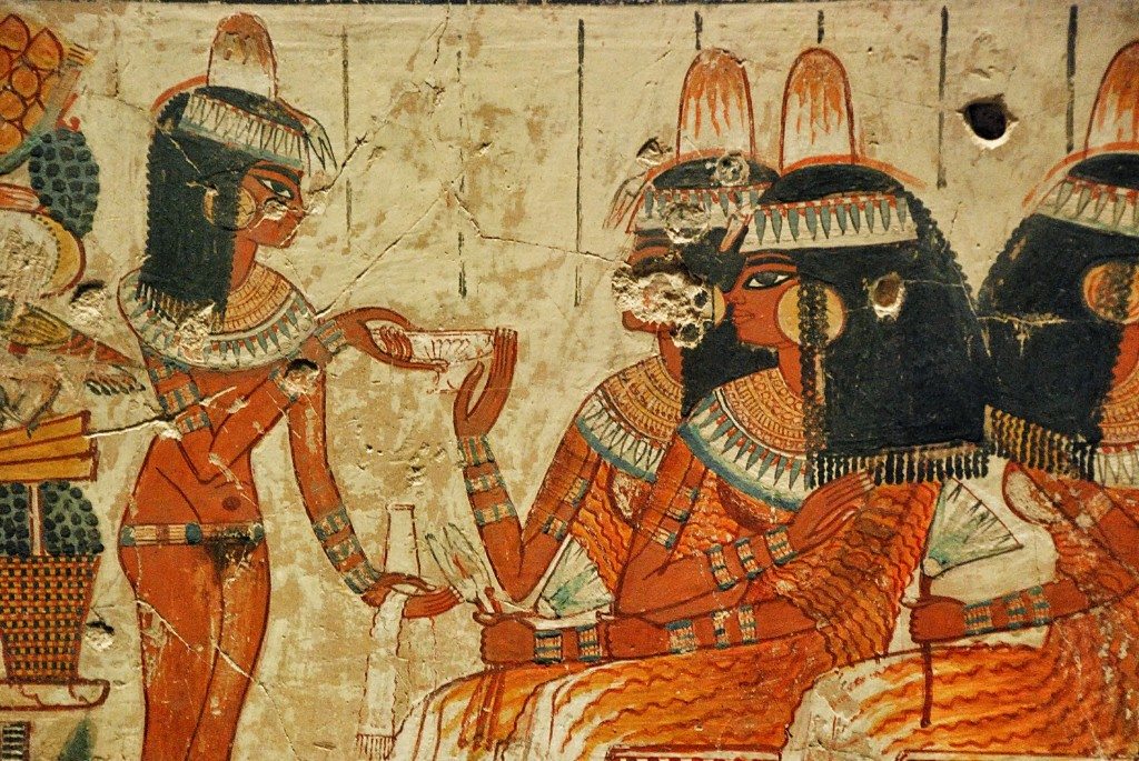 A naked lady brings offerings to Nebamun's wife.