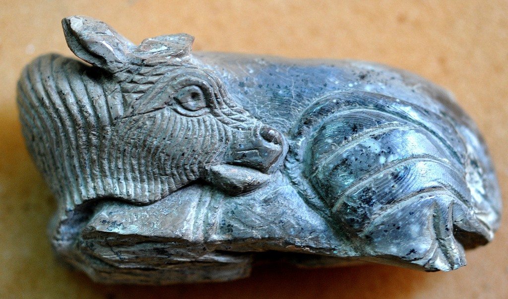 An exquisitely carved plaque of a supine bull. Note the black burn mark. Probably, this was part of a group which once supported an ivory tray. Neo-Assyrian period, 9th-7th centuries BCE. From Nimrud, Mesopotamia, Iraq. (The Sulaimaniya Museum, Iraq). 