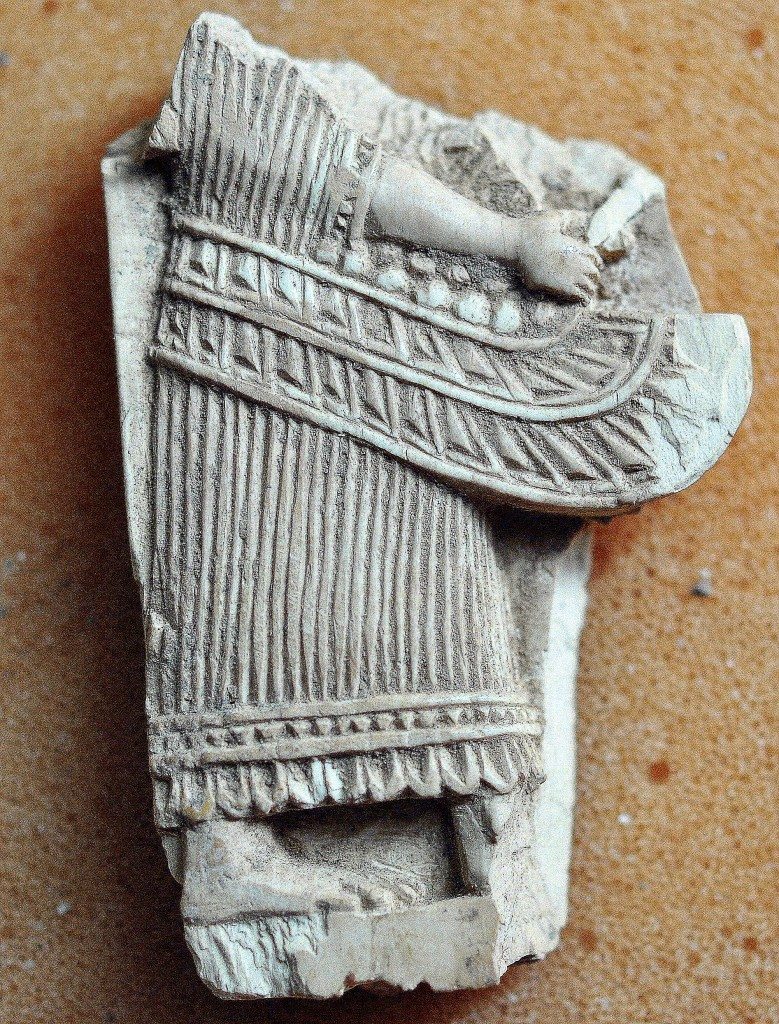 The lower half the body of person with his wing appears in this broken ivory plaque. Neo-Assyrian period, 9th-7th centuries BCE. From Nimrud, Mesopotamia, Iraq. (The Sulaimaniya Museum, Iraq). 