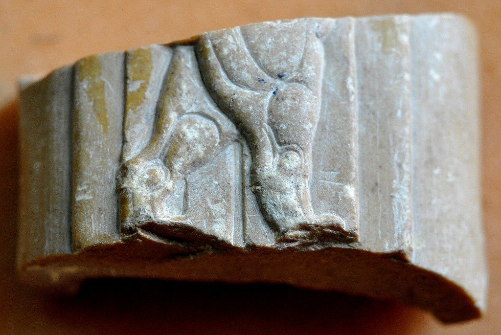 The thighs, knees, and upper part of the legs of a creature (animal?) can be seen in this broken ivory plaque. The back of the plaque is hollow and it seems that it fits something. In this broken ivory plaque, the tail and the hind legs of a 4-legged animal appear. Neo-Assyrian period, 9th-7th centuries BCE. From Nimrud, Mesopotamia, Iraq. (The Sulaimaniya Museum, Iraq).