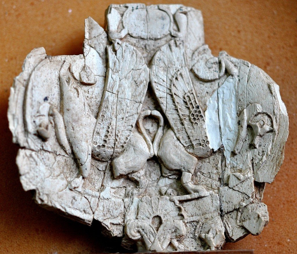 Partially damaged ivory plaque which depicts 2 winged 4-legged animals. The animals are striding, back to back. Neo-Assyrian period, 9th-7th centuries BCE. From Nimrud, Mesopotamia, Iraq. (The Sulaimaniya Museum, Iraq). 