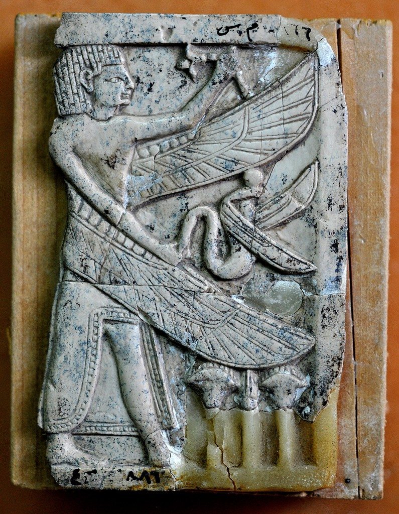 This carved ivory plaque depicts a standing man with an Egyptian hair style. The man has 2 wings and holds a snake. Neo-Assyrian period, 9th-7th centuries BCE. From Nimrud, Mesopotamia, Iraq. (The Sulaimaniya Museum, Iraq). 