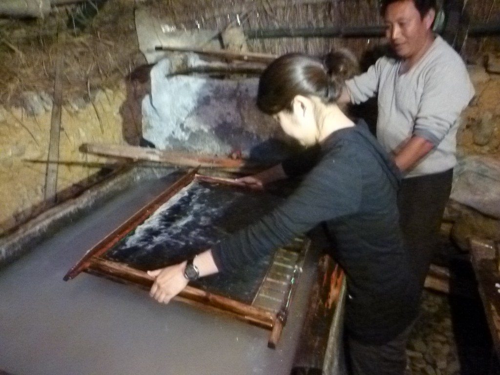 GHF Project Director Han Li scooping paper in China. (Courtesy of GHF.) 
