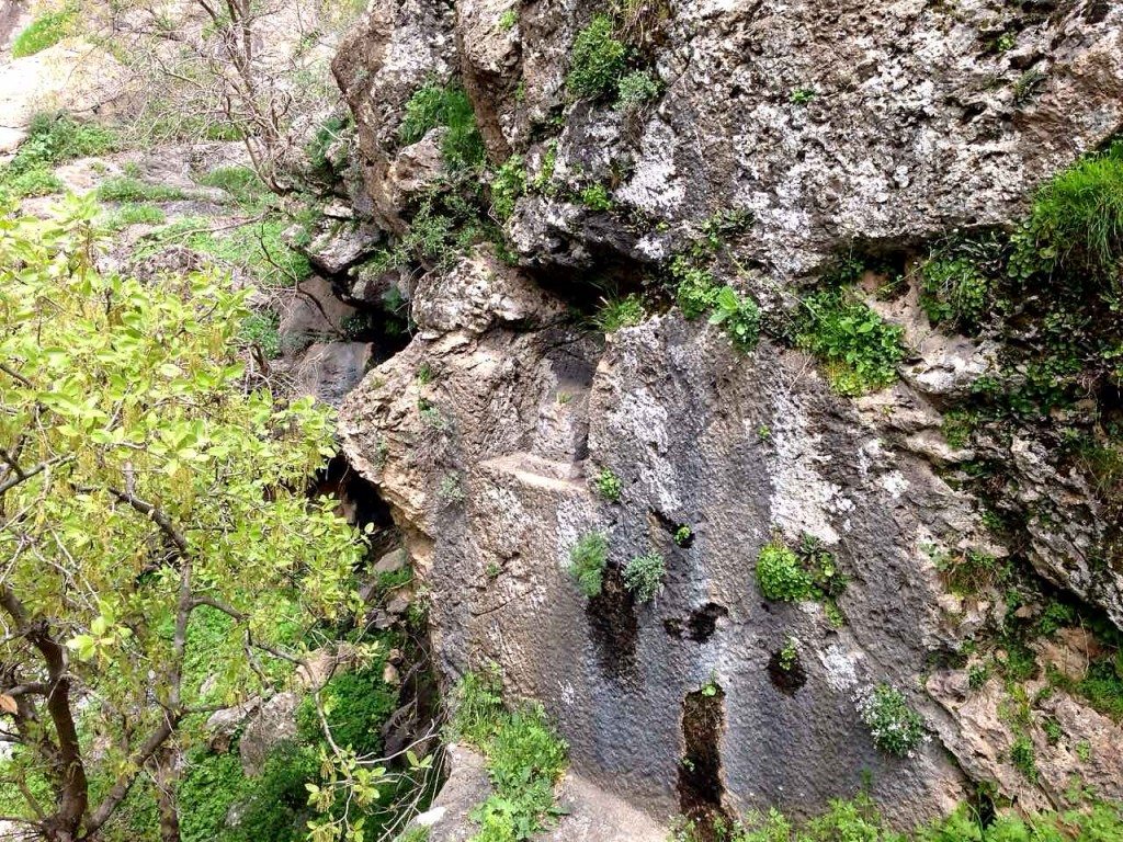 This pit within the cliff contains a statue of a deity. The upper part was damaged deliberately during the 1950 CE by local villagers in response to a religious advice. 