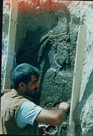 Making Merquli's replica on the original rock relief. August 2000. Photo courtesy Mr. Akam Omar. 