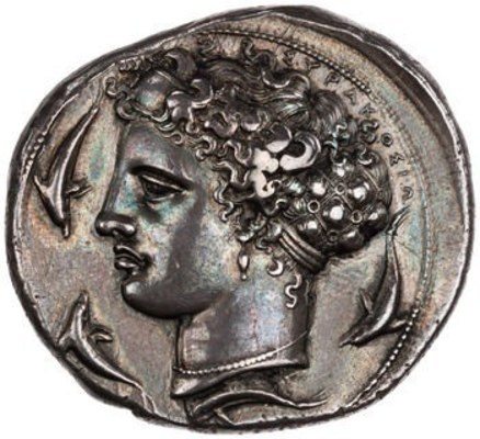 ​10 Drachm (decadrachm) with Arethusa from Syracuse, 405-400 BCE. The American Numismatic Society (1964.79.21). Arethusa’s hair is gathered in an ampyx, a leather or metal band just above her forehead, which is connected to a large open-work hairnet filled with her long hair. This late 5th century BCE version of Arethusa shows richly textured, curly hair, with short loose ends projecting outward along the top of her head along with the inscription ΣΥΡΑΚΟΣΙΟ (Syracuse). The hairnet shows long locks of hair in each section, with surfaces now partly worn, separated by small discs decorating the interstices of the net. While the hairnet is intended to control Arethusa’s hair, it more successfully brings attention to the coils escaping from it. Such an elaborate hair accessory, presumably made of metal, is related to the Hairnet with Medallion (no. 31), and both exemplify the luxurious nature of hair accessories in the Greek Classical and Hellenistic periods. 