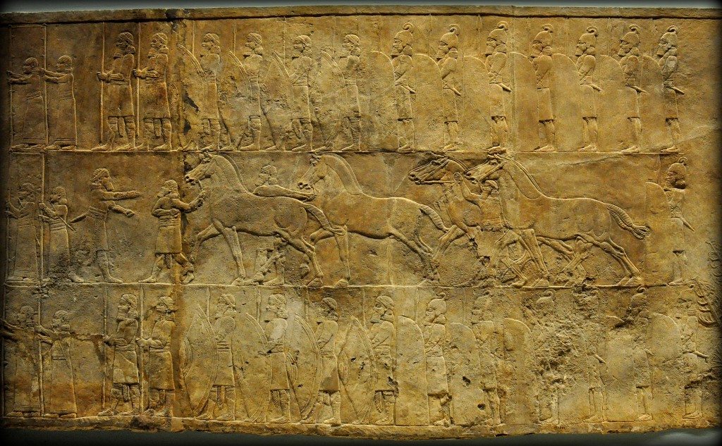 Assyrian Lion. In this alabaster bas-relief, grooms appear to lead horses towards a screened enclosure within which a royal chariot is being prepared for the hunt. Men are struggling to push one of the horses into position while another horse is having his harness tightened. From Room C of the North Palace, Nineveh (modern-day Kouyunjik, Mosul Governorate), Mesopotamia, Iraq. Circa 645-535 BCE. The British Museum, London. Photo©Osama S.M. Amin. 