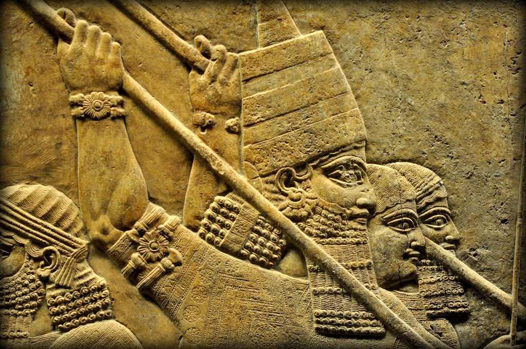 Assyrian Lion. Detail of an alabaster-bas relief depicting the Assyrian king Ashurbanipal. The king is identified by his conical head cap. He holds a long spear and stabs a leaping lion in his head. Note the exquisitely carved embroidery, armlets, earring, and costume. Two royal attendants ward off the lion with their spear. One of his royal attendants is guiding the royal chariot. From Room C of the North Palace, Nineveh (modern-day Kouyunjik, Mosul Governorate), Mesopotamia, Iraq. Circa 645-535 BCE. The British Museum, London. Photo©Osama S.M. Amin.
