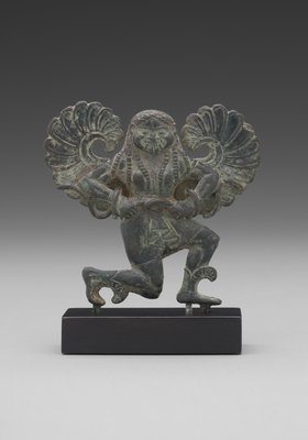 ​Statuette of a Running Gorgon, 540 BCE. We see Medusa before Perseus reaches her: A Greek female in the 6th century BCE wearing long hair usually represented a maiden, which was Medusa’s previous status. Here she has abundant long textured hair, both sinuous and segmented to describe wavy texture. In later Greek art her hair will appear as intertwined snakes coiling and writhing across her head. Snakes coiling around her arms and interlocking at her waist in this statuette introduce this serpentine element that will form an integral part of her appearance.