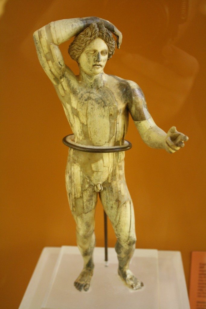 An ivory statuette of Apollo Lykeios, 3rd Century BCE. The statuette was restored after being found in 200 pieces at the bottom of a well. (Agora Museum, Athens)
