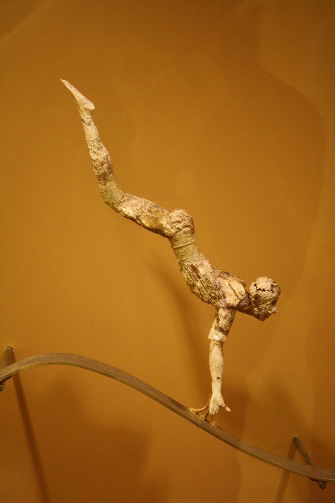 An ivory figurine representating a bull-leaper from a three dimensional composition (with two other figures and a bull) depicting this Minoan sporting or religious activity. Hair would have been added using bronze wire and clothes in gold leaf, 1600-1500 BCE. It is perhaps the earliest known attempt in sculpture to capture free movement in space. (Archaeological Museum Herakleion)