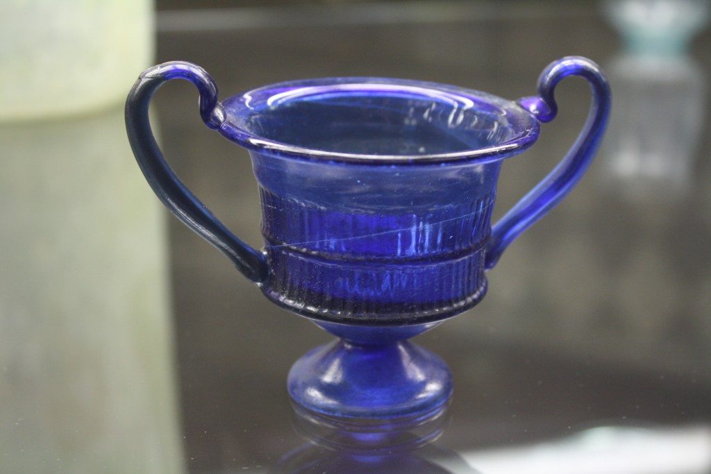A glass kantharos or drinking cup. Roman glassware at the Archaeological Museum of Pavia. Image © Mark Cartwright.