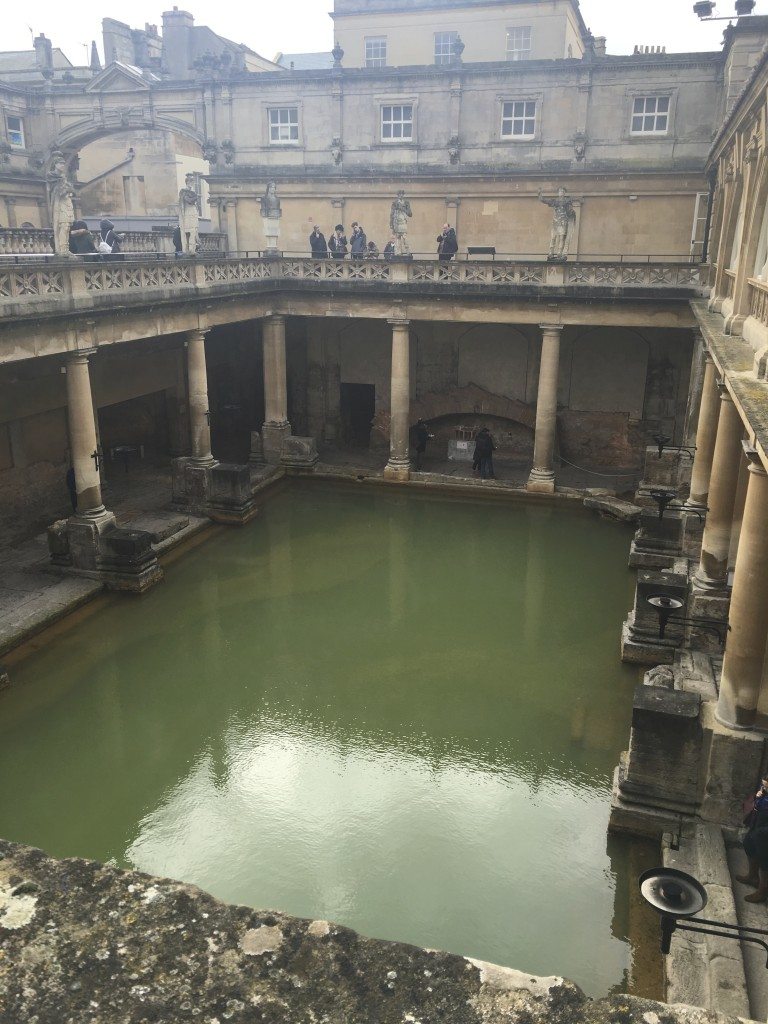 Mist rises from the water in the Great Bath at the Roman baths. Image © Caroline Cervera.