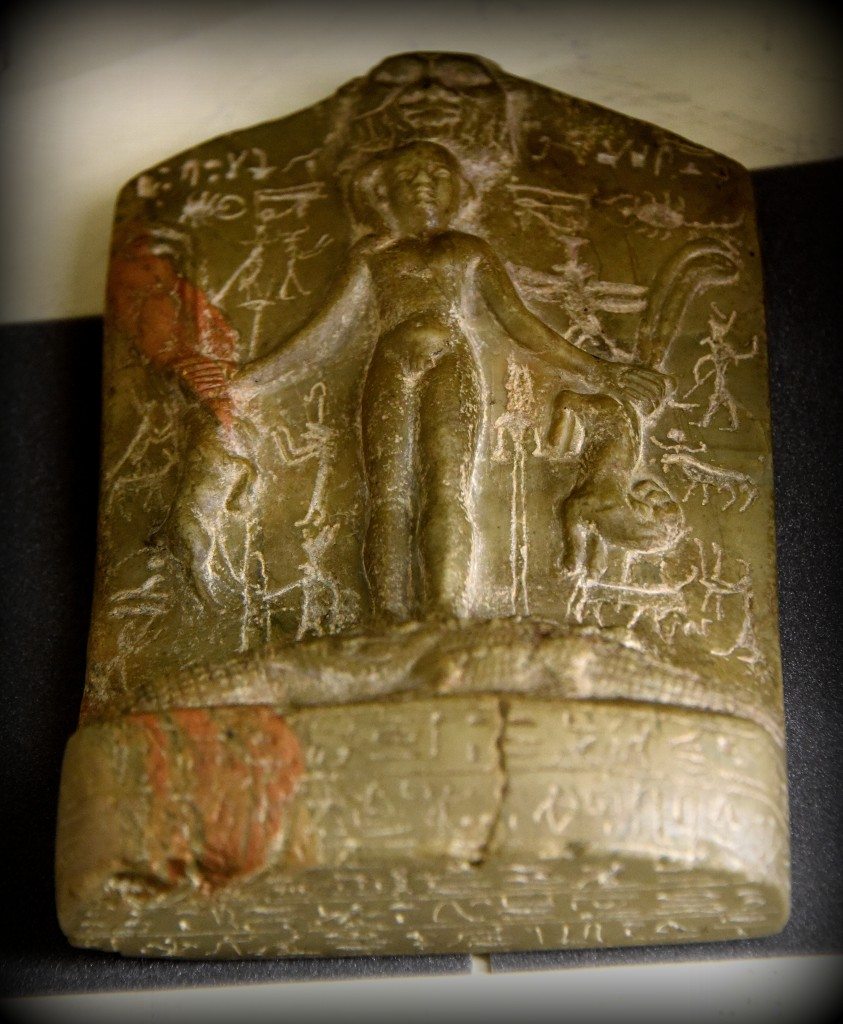 This is a protective amulet called "cippus or Horus stela". It depicts the god Horus as a naked child, standing on 2 crocodiles with oryx and serpents in each hand. God Bes can be seen at the upper part. The cippus is inscribed in hieroglyphs on all faces with words to be spoken in defence of health (mainly against snake and scorpion bites). From Egypt. Ptolemaic Period, 305-30 BCE. With thanks to the Petrie Museum of Egyptian Archaeology. Photo © Osama S. M. Amin. 