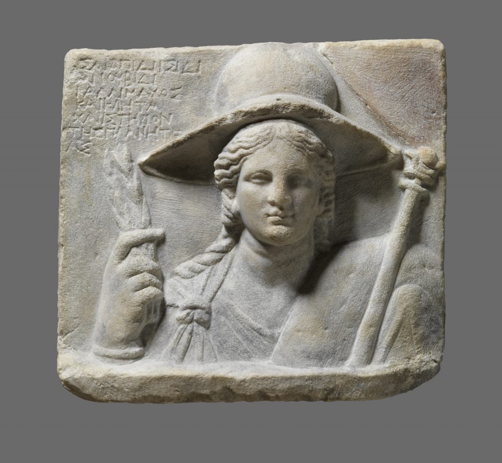 Relief Stele Depicting Isis as Demeter with Dedicatory Inscription. Second half of 3rd–early 2nd century BC. Marble. H. 12.2 in; W. 13.4 in; D. 3.1 in (H. 31 cm; W. 34 cm; D. 8 cm). From Dion. Sanctuary of Isis, Courtyard of the temple of Isis Lochia. Archaeological Museum of Dion. Photo © Hellenic Ministry of Culture and Sports, Ephorate of Antiquities of Pieria, and the Dion Excavations. Courtesy Onassis Cultural Center NY.