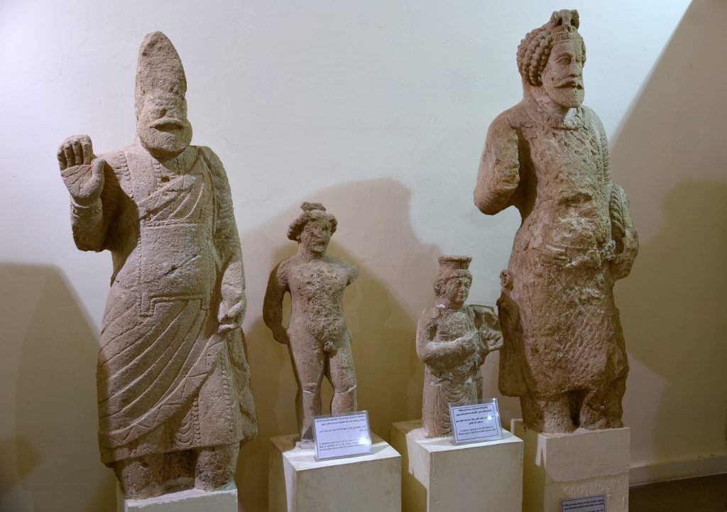 From left to right: Life-size statue of an unknown leader/ruler from Hatra; a small statue depicting an unidentified deity but it might well represent the messenger god Hermes; small statue of an unidentified female deity; life-size statue of king Sanatruq I. From Hatra, modern-day Mosul Governorate, Iraq. 1st century CE. Erbil Civilization Museum, Iraqi Kurdistan. Photo © Osama S. M. Amin.
