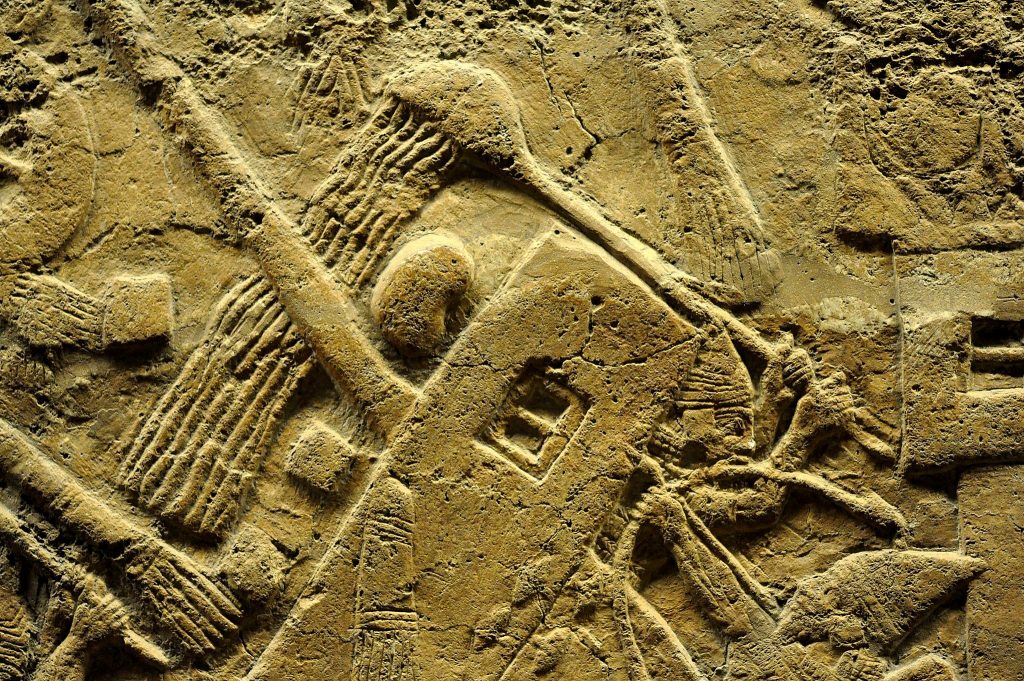 This is one of the very dynamic and live scenes which was conveyed to us by the reporter (artist). The battering ram of the siege engine is being attacked by fire torches, which were thrown by the soldiers of Lachish. One of the Assyrian soldiers, within the engine, is ready and seems to anticipate this attack. He is pouring water on the engine in order to catch fire. The front side of the engine is hitting falling stones, but it seems that the engine is immune to this attack. From Nineveh (modern-day Mosul Governorate, Iraq), Room XXXVI of the South-West Palace, panels 7. The British Museum, London. Photo © Osama S. M. Amin.