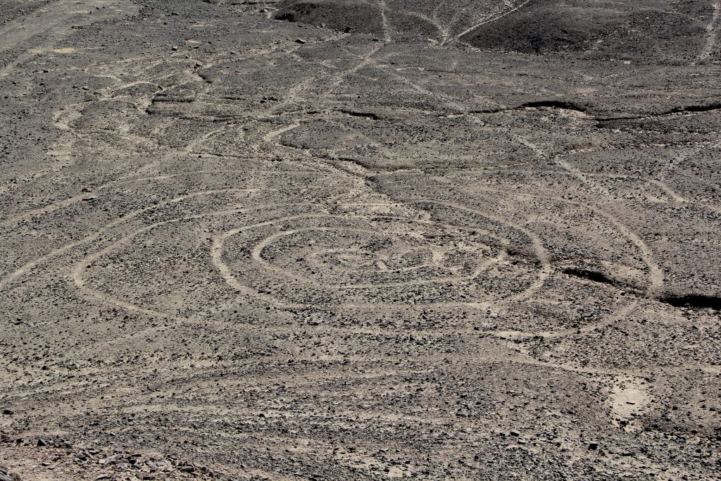 The spiral begins in at a central point and infinitely winds outwards into eternity. Image © Caroline Cervera. Nazca lines
