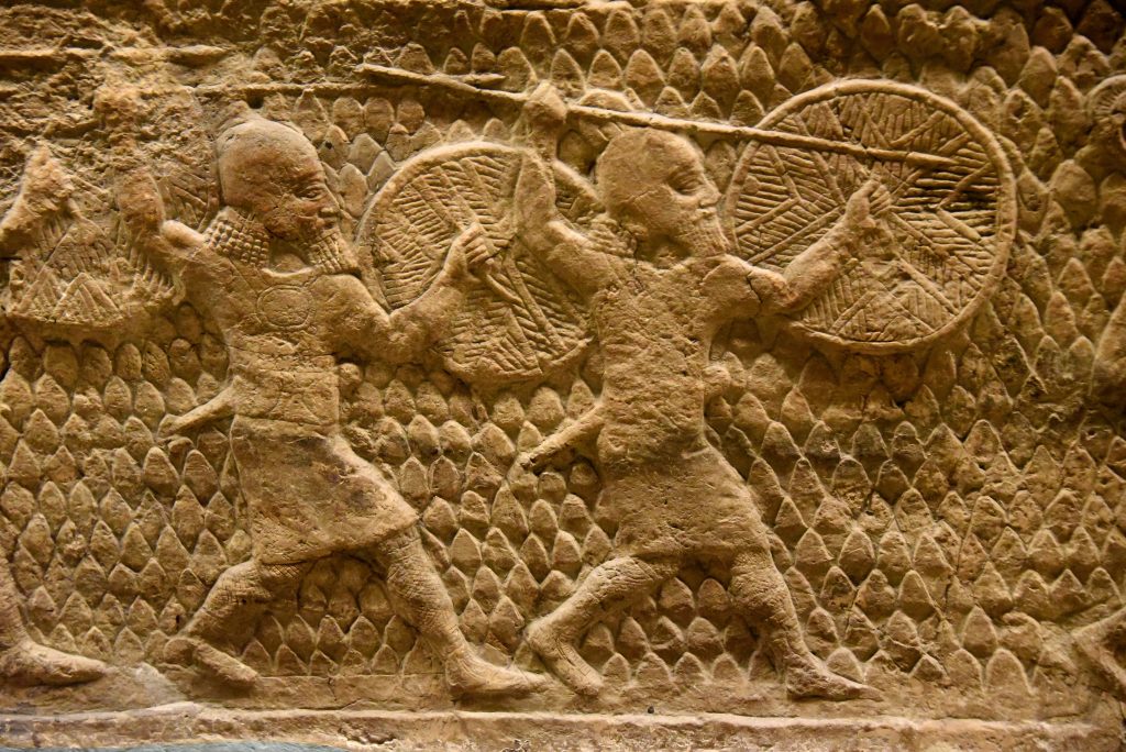 The beginning of the attack on Lachish in 701 BCE. This is a detail of a large stone wall panel which shows Assyrian soldiers in action, holding their long spears and rounded shields. From Nineveh (modern-day Mosul Governorate, Iraq), Room XXXVI of the South-West Palace, panels 5-6. The British Museum, London. Photo © Osama S. M. Amin.