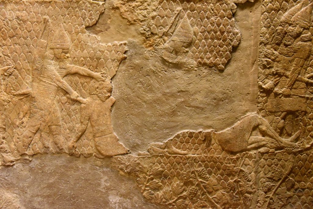 Some of the prisoners are being "beheaded". The one on the left is about to get his through cut by an Assyrian soldier. Another one on the right (most of his body was lost) was already beheaded and dead; his supine and flaccid posture suggest that. The Assyrian literature clearly mentioned that only the heads of a rebellion or enemy (king, prince, commander-in-chief, high ranking officials,...etc.) face execution, usually through beheading. From Nineveh (modern-day Mosul Governorate, Iraq), Room XXXVI of the South-West Palace, panels 11-13. The British Museum, London. Photo © Osama S. M. Amin. 